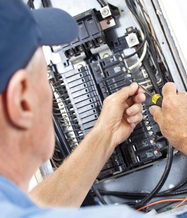 Electrician doing electrical work in breaker box