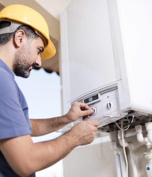 Boiler technician working in home.